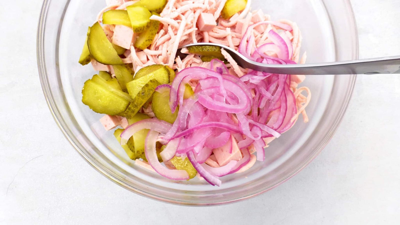 Classic Bavarian wurstsalat, a German bologna sausage salad with cherry tomatoes, vinegar, red onion and pickled gherkins!