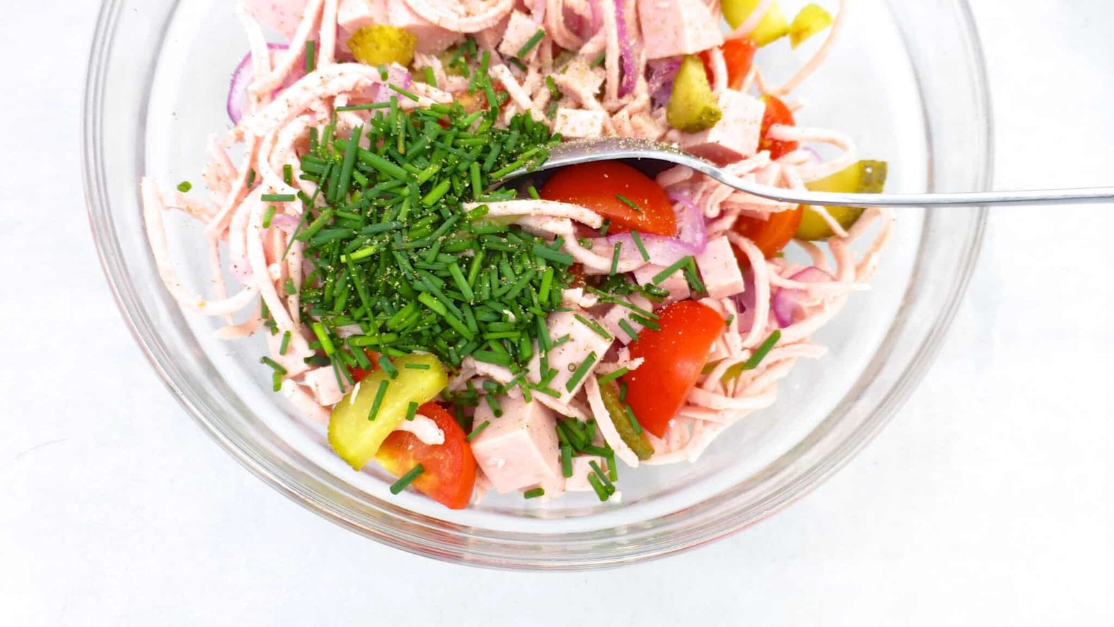 Classic Bavarian wurstsalat, a German bologna sausage salad with cherry tomatoes, vinegar, red onion and pickled gherkins!