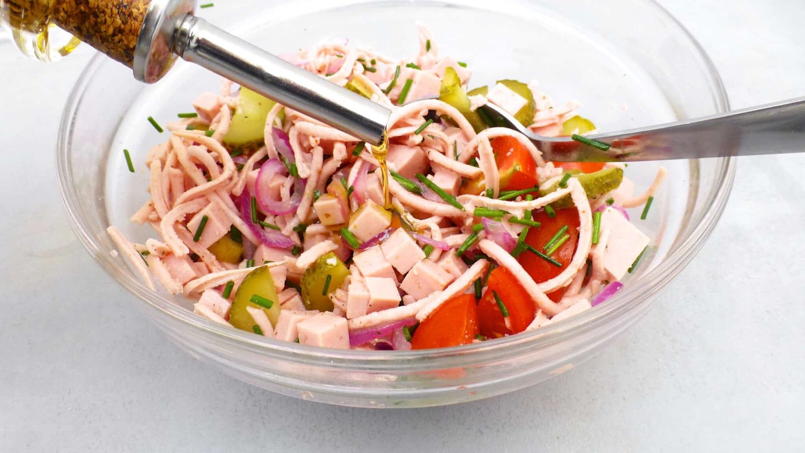 Classic Bavarian wurstsalat, a German bologna sausage salad with cherry tomatoes, vinegar, red onion and pickled gherkins!