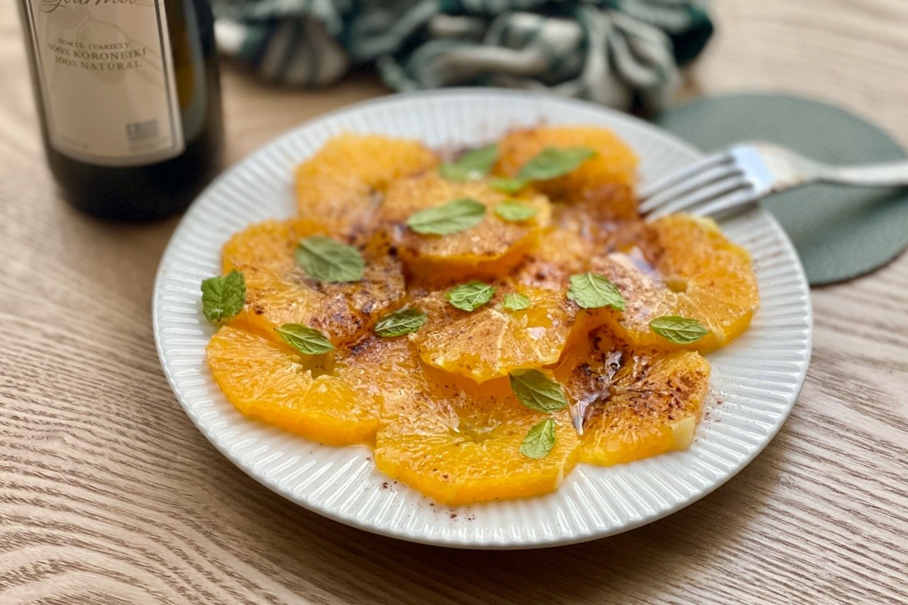 Best Mediterranean Orange Carpaccio (Fresh Citrus Carpaccio Dessert) Mediterranean orange carpaccio with olive oil, cinnamon, and mint on a white plate.